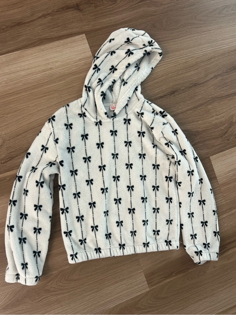 Cozy White Hooded Sweater with Black Bow Pattern